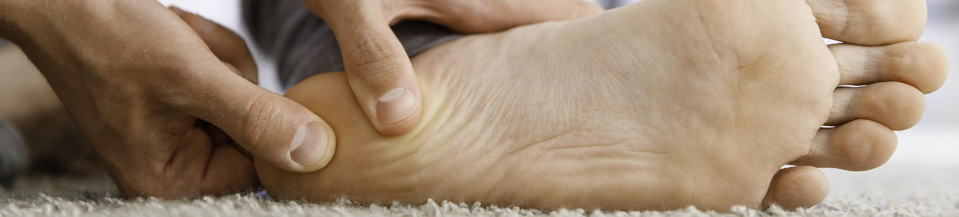 a person suffering from foot plantar fasciitis