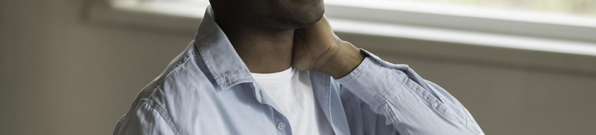 Man with neck pain seeking pinched nerve relief treatment