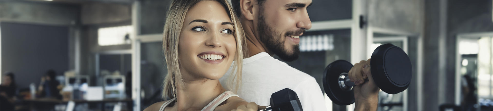 young fit couple working out at the gym