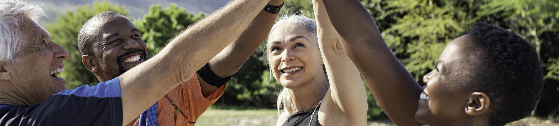 group of happy mature sporty people exercising outdoors