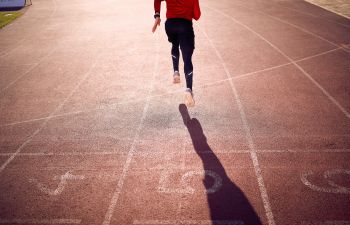 Athlete running on a race track.